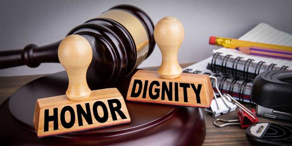 two stamps on a gavel, one says honor and the other says dignity