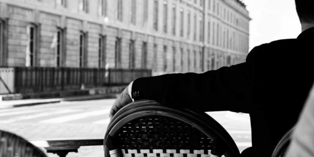 Man in a suit sitting alone