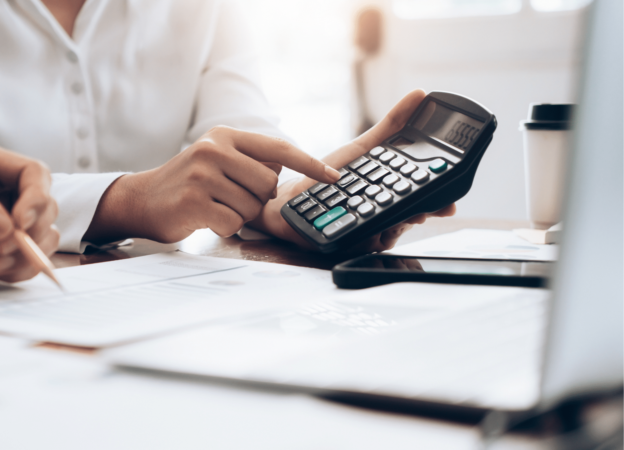 Person pointing at a calculator