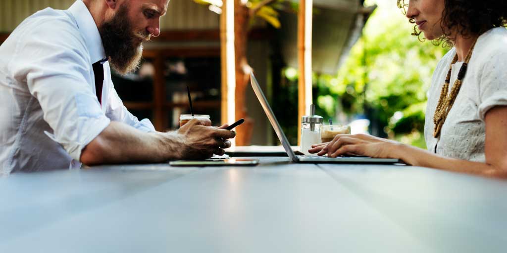 lawyers working outside on laptop and mobile phones