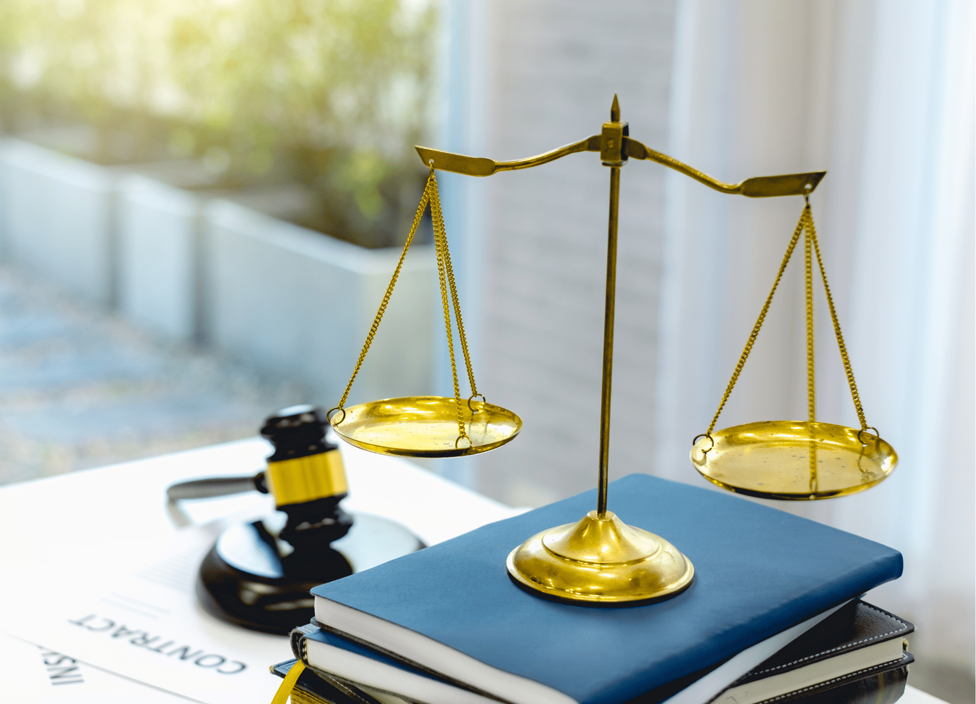 Scale on top of stack of books with gavel next to it